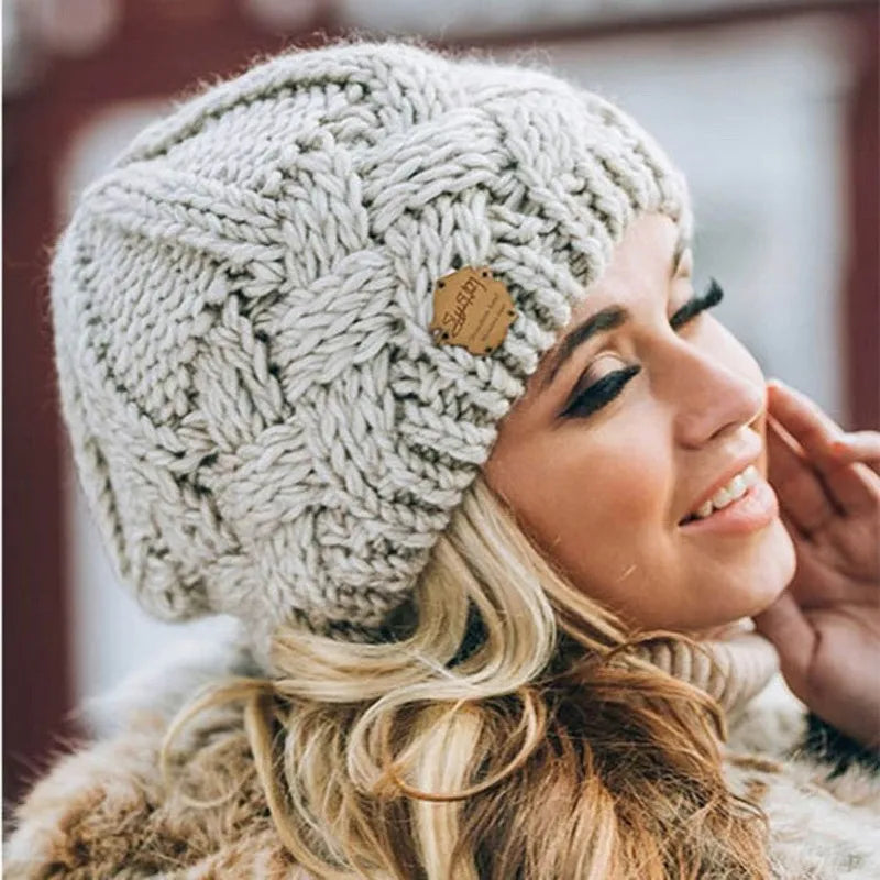 Knitted cable-pattern beanie with decorative patch