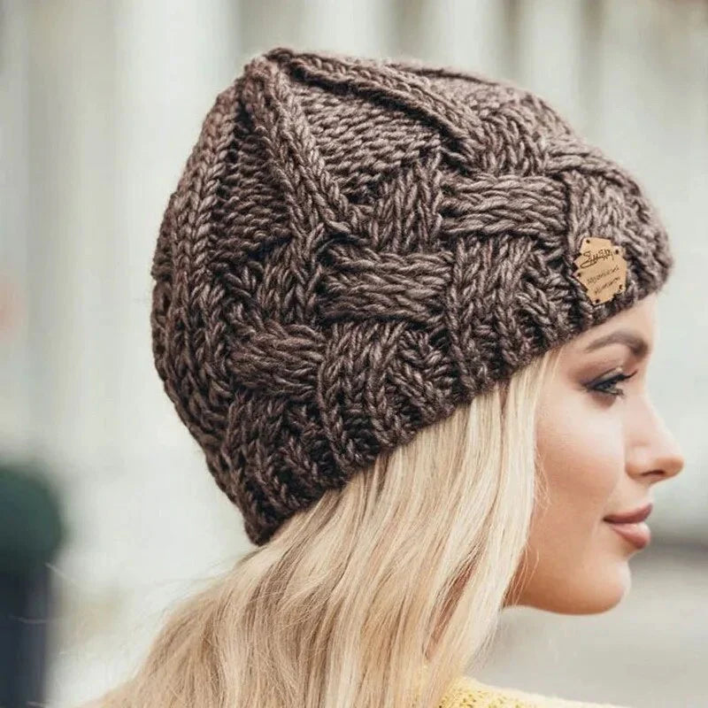 Knitted cable-pattern beanie with decorative patch