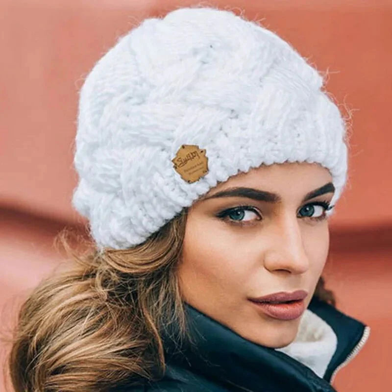 Knitted cable-pattern beanie with decorative patch