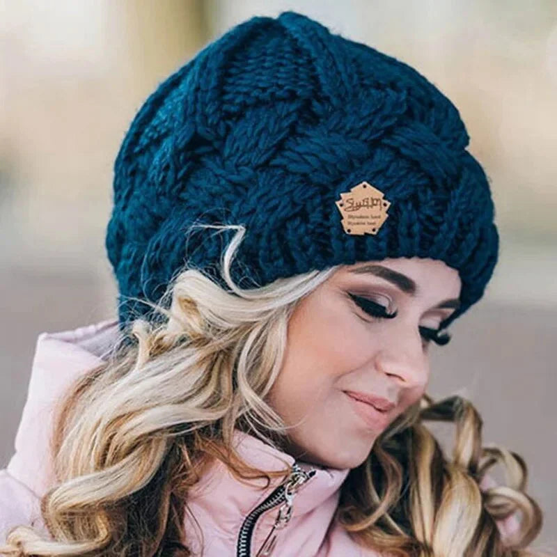 Knitted cable-pattern beanie with decorative patch