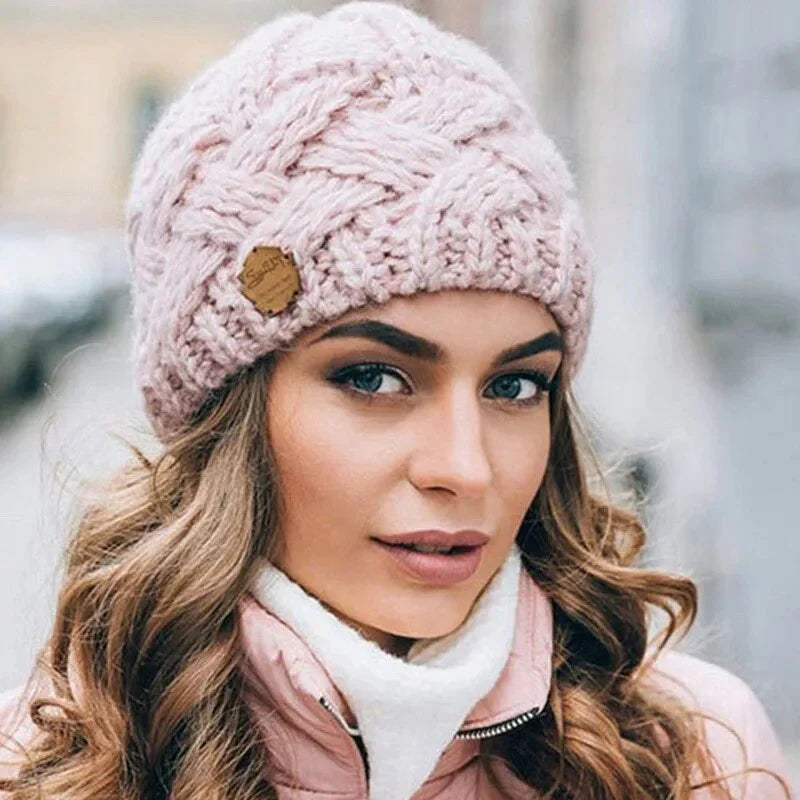 Knitted cable-pattern beanie with decorative patch