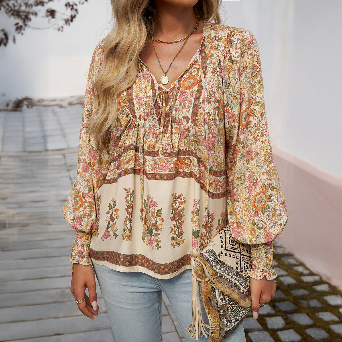 Women's blouse with V-neck, long sleeves and eye-catching pattern