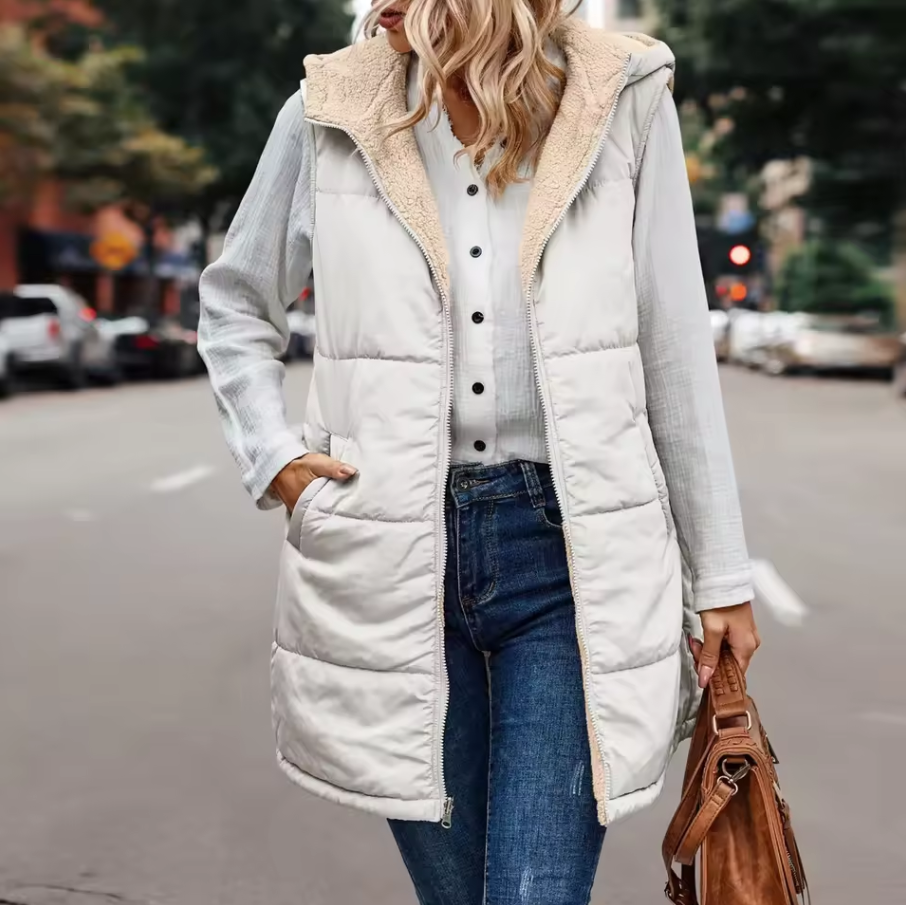 Long quilted vest with hood and button closure