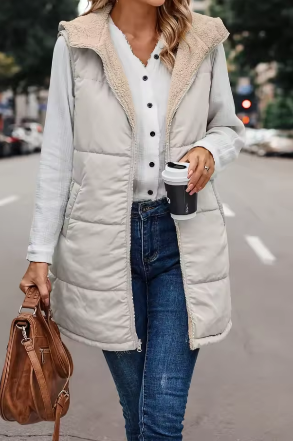 Long quilted vest with hood and button closure
