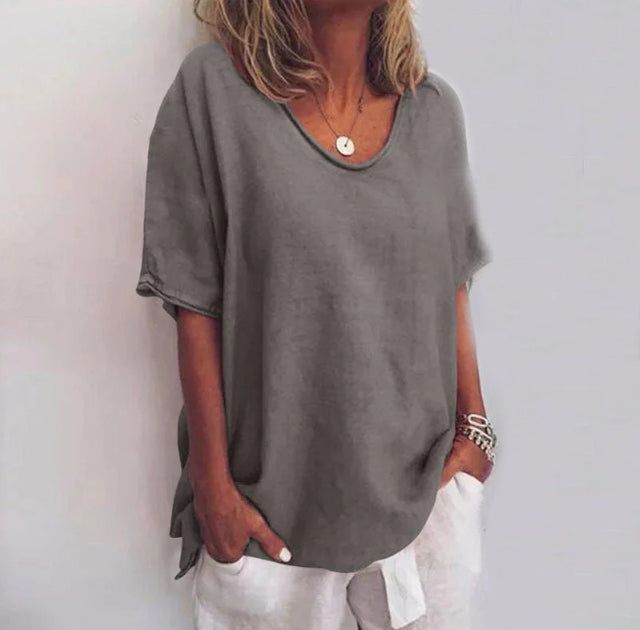 Loose-fitting women's blouse with round neck and tie details on the sleeves