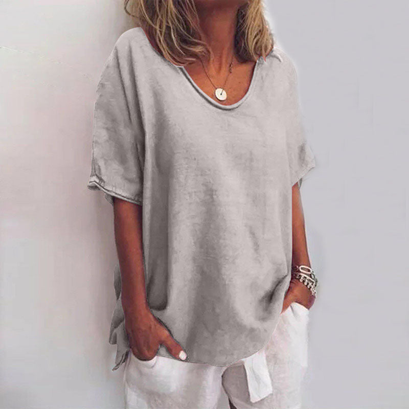 Loose-fitting women's blouse with round neck and tie details on the sleeves