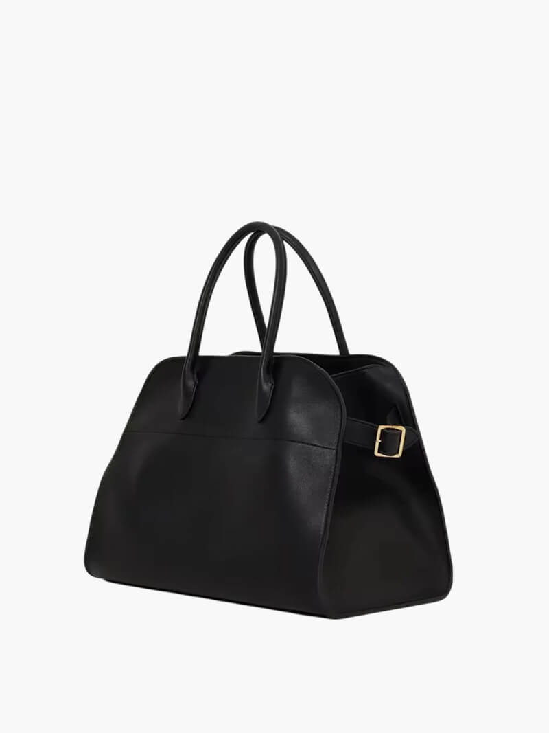 Handbag with textured material and zipper closure