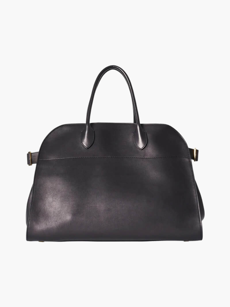Handbag with textured material and zipper closure