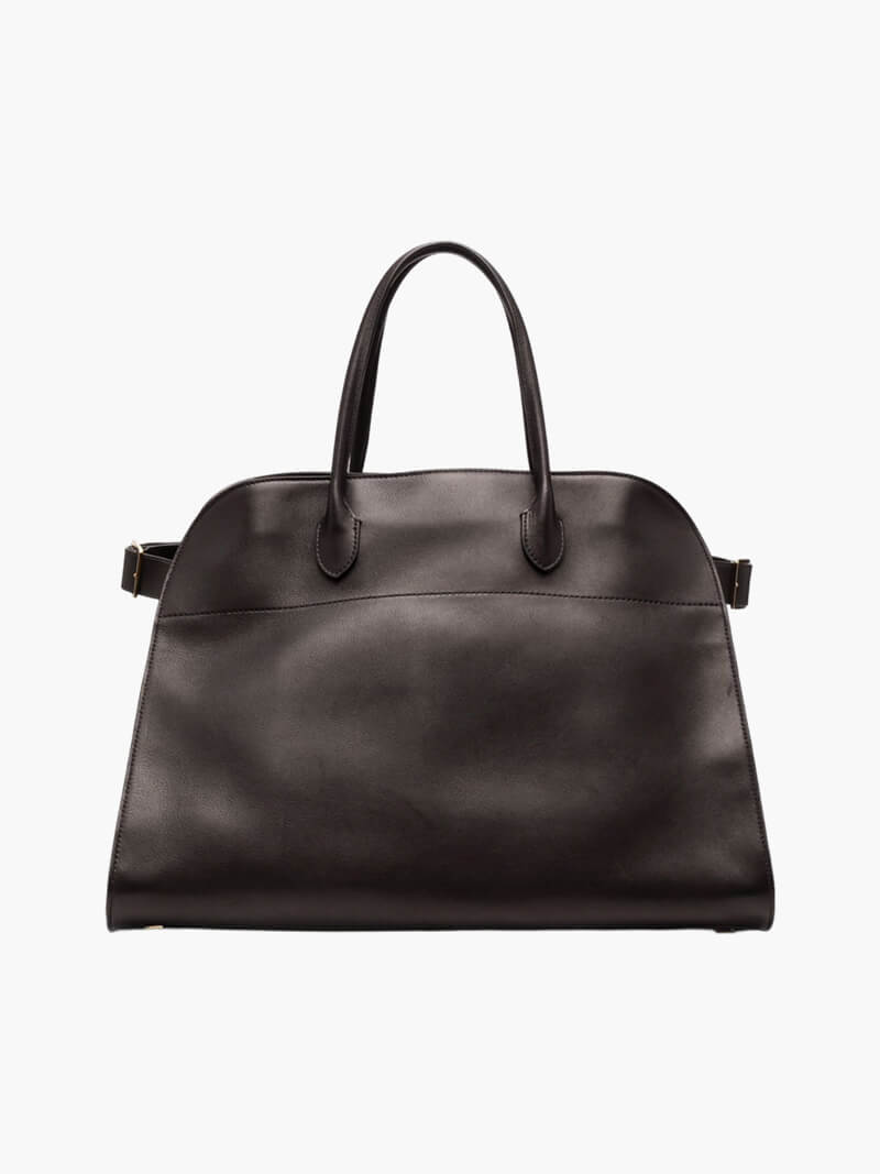 Handbag with textured material and zipper closure