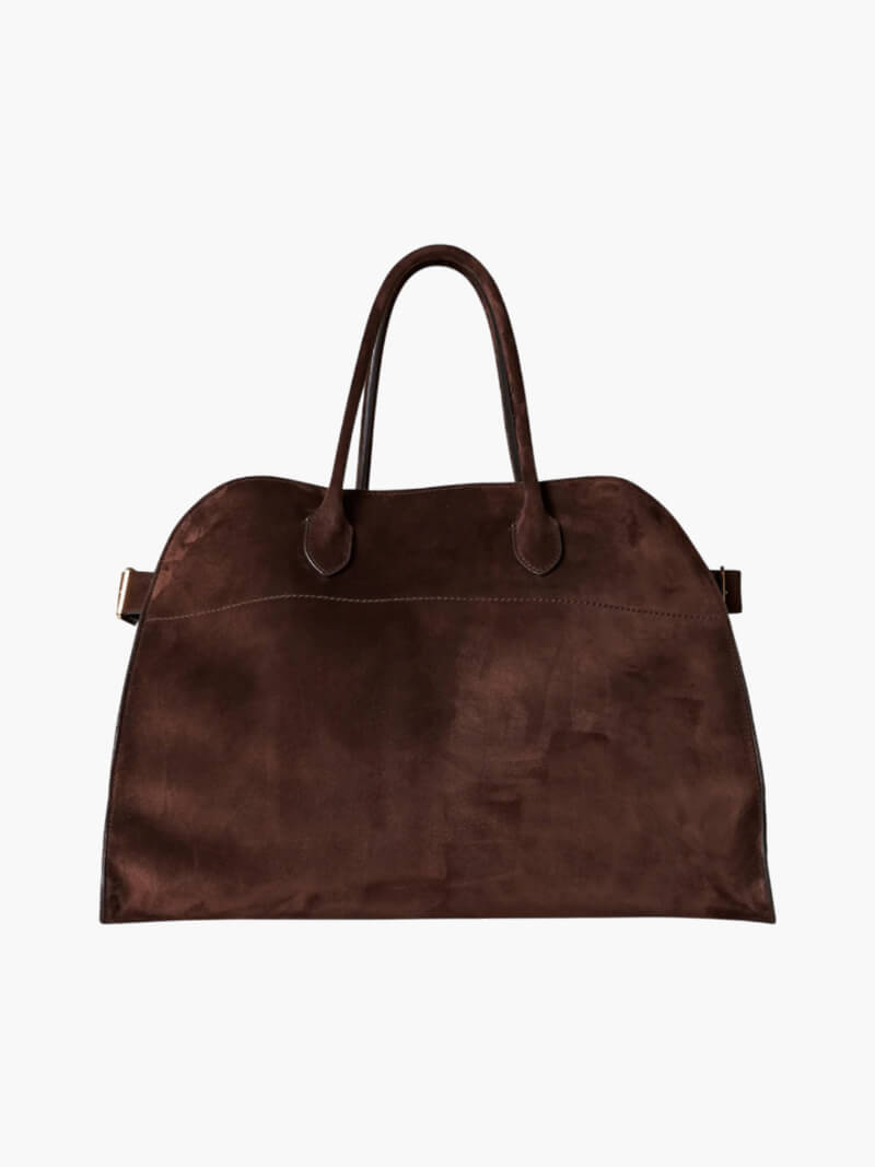 Handbag with textured material and zipper closure