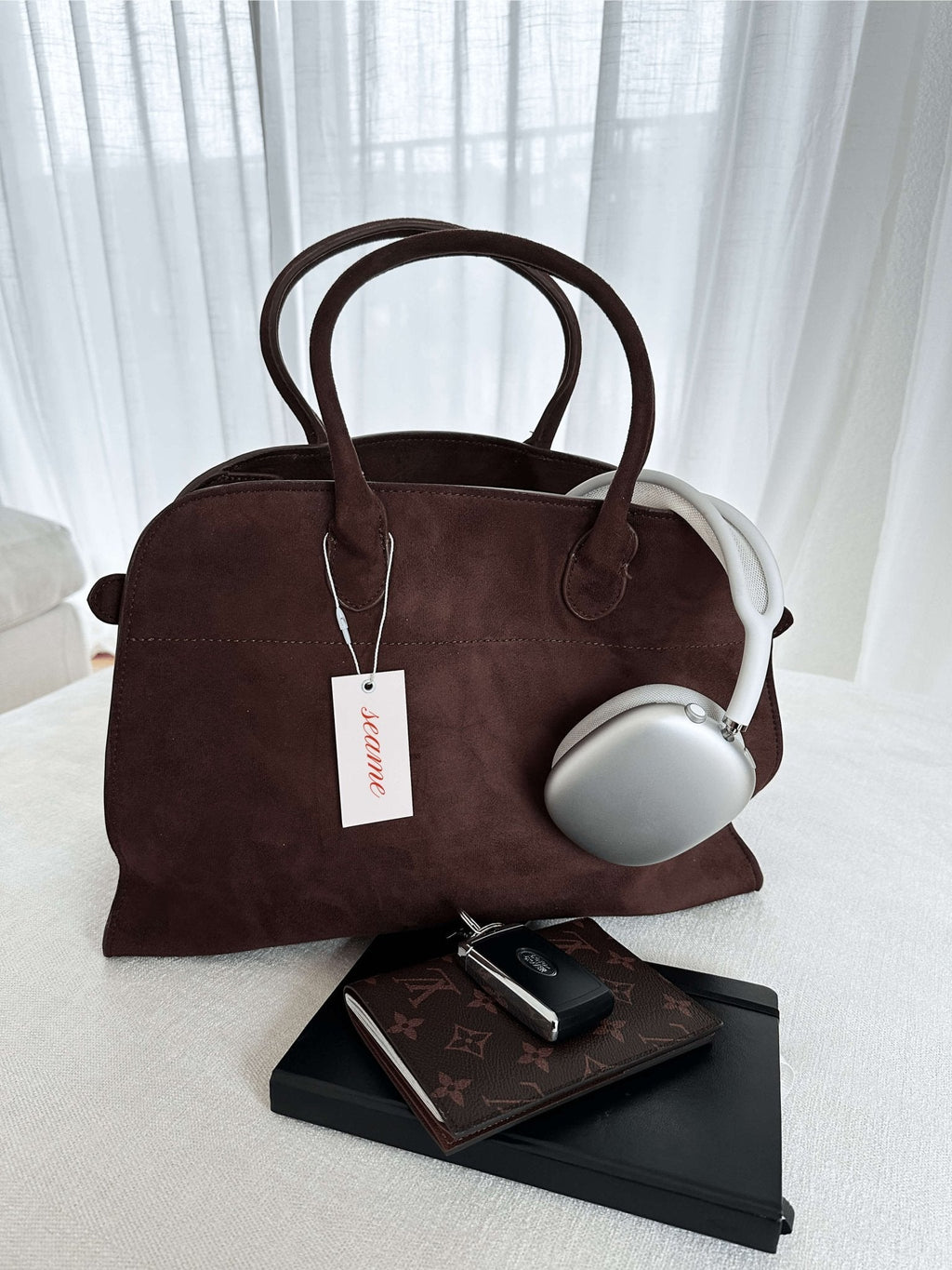 Handbag with textured material and zipper closure