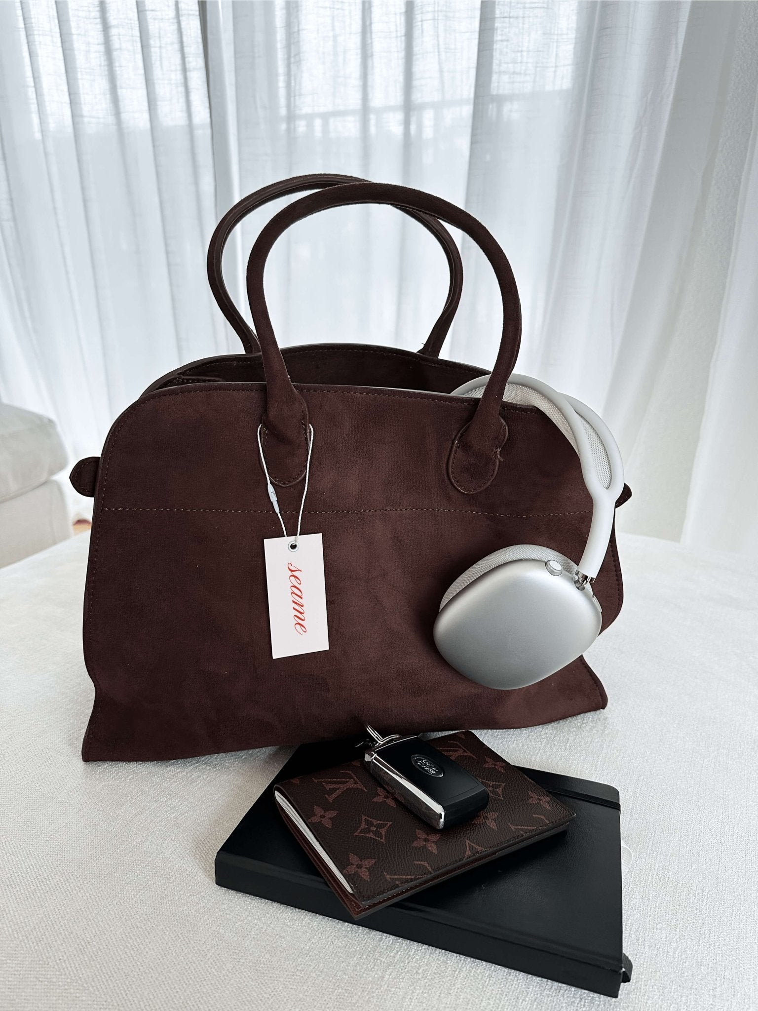 Handbag with textured material and zipper closure