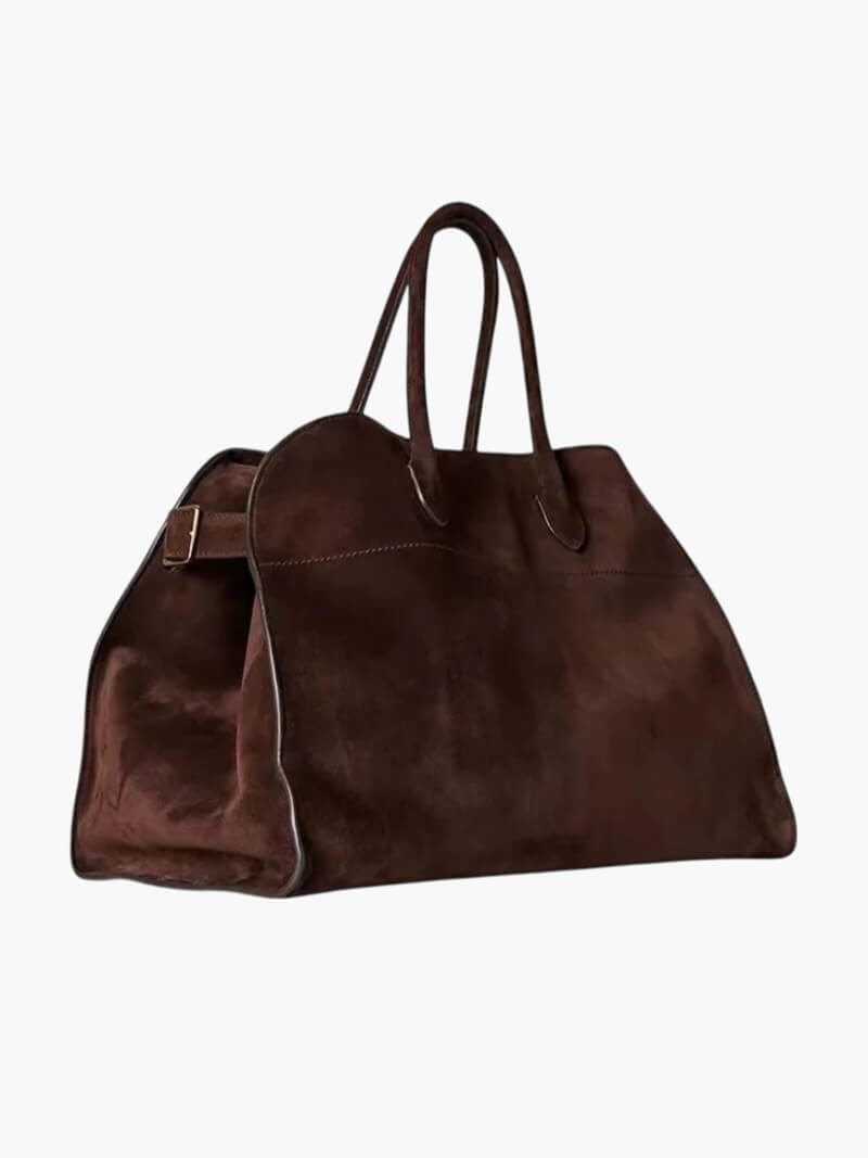 Handbag with textured material and zipper closure