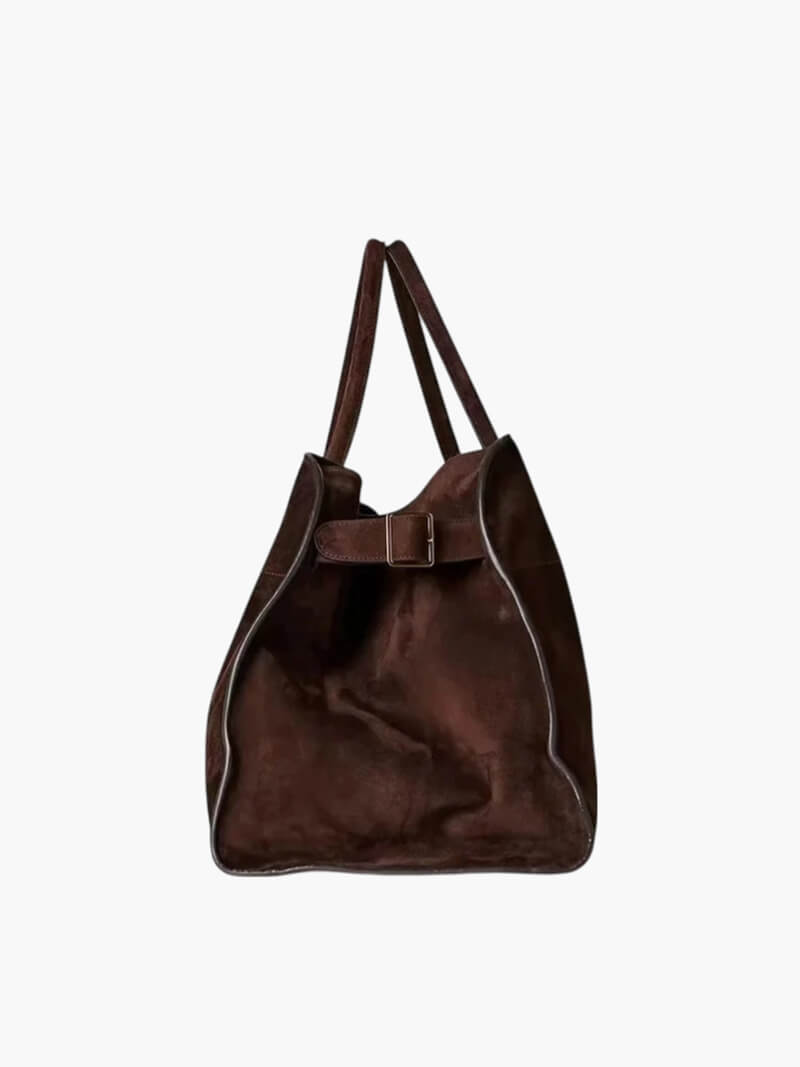 Handbag with textured material and zipper closure