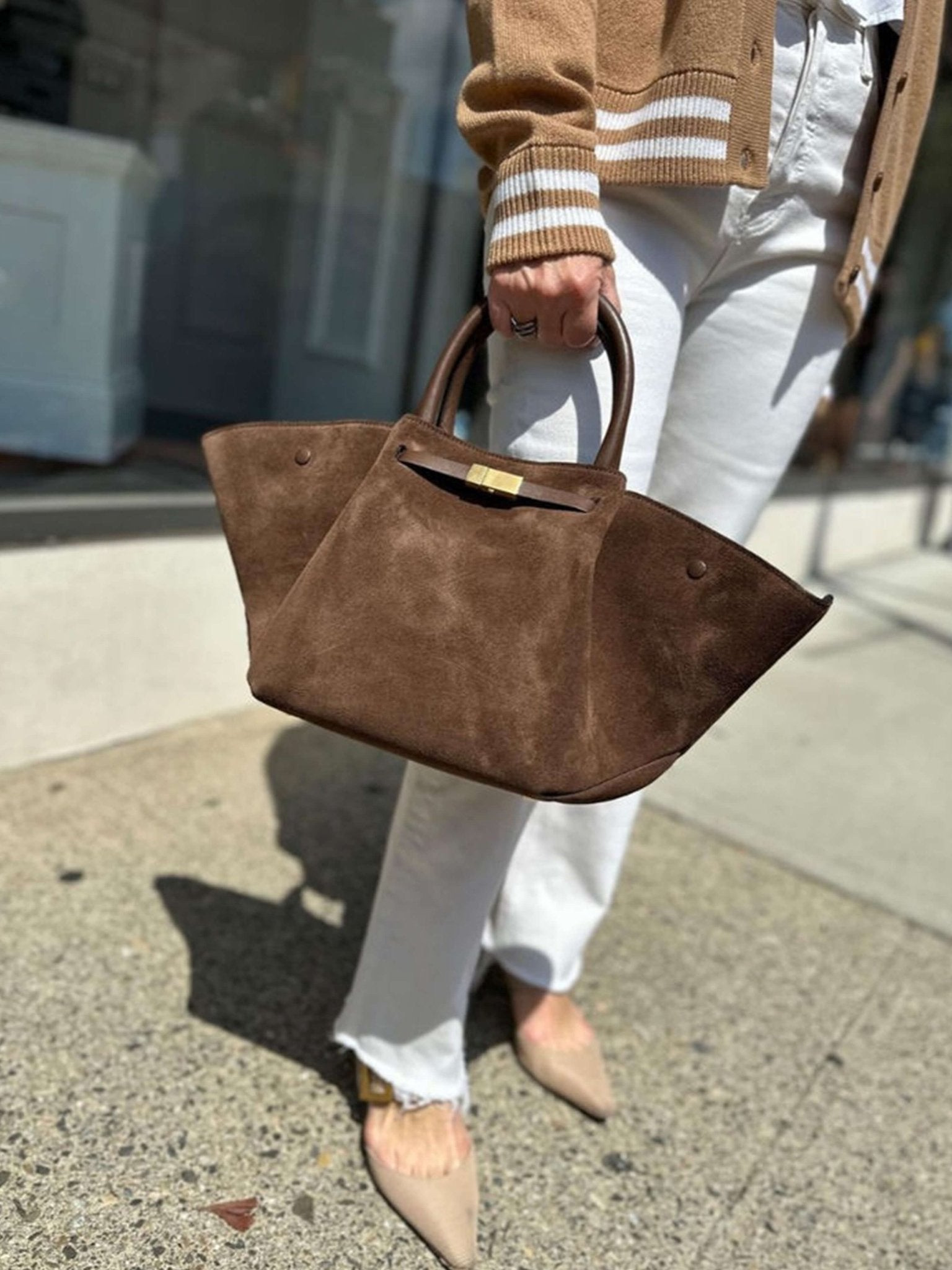 Handbag with handles, detachable strap, and structured design