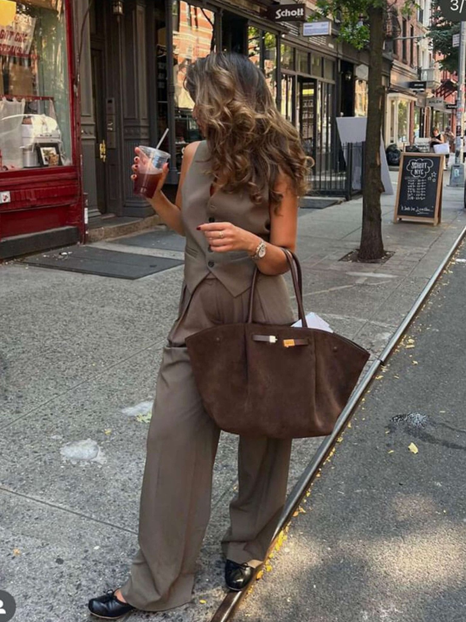 Handbag with handles, detachable strap, and structured design