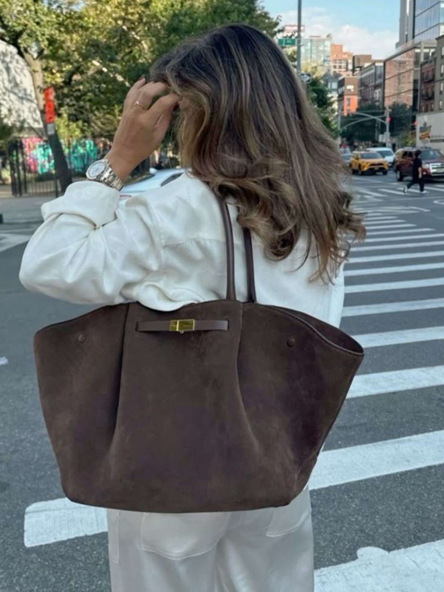 Handbag with handles, detachable strap, and structured design