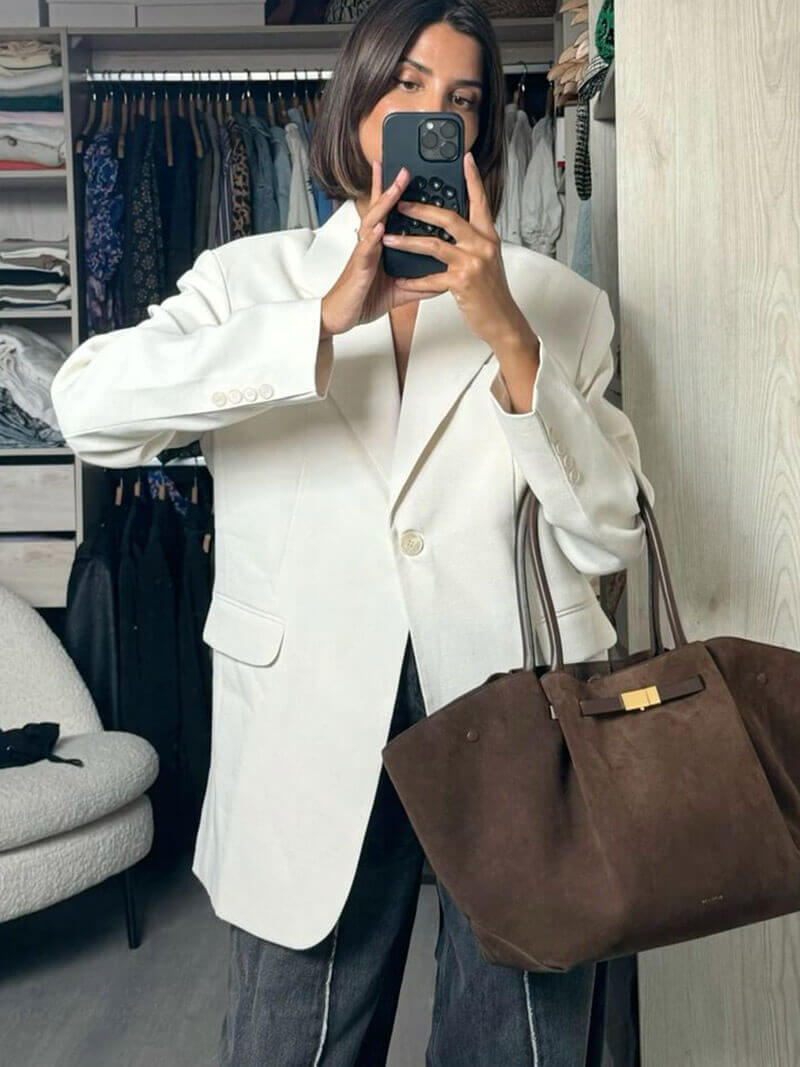 Handbag with handles, detachable strap, and structured design