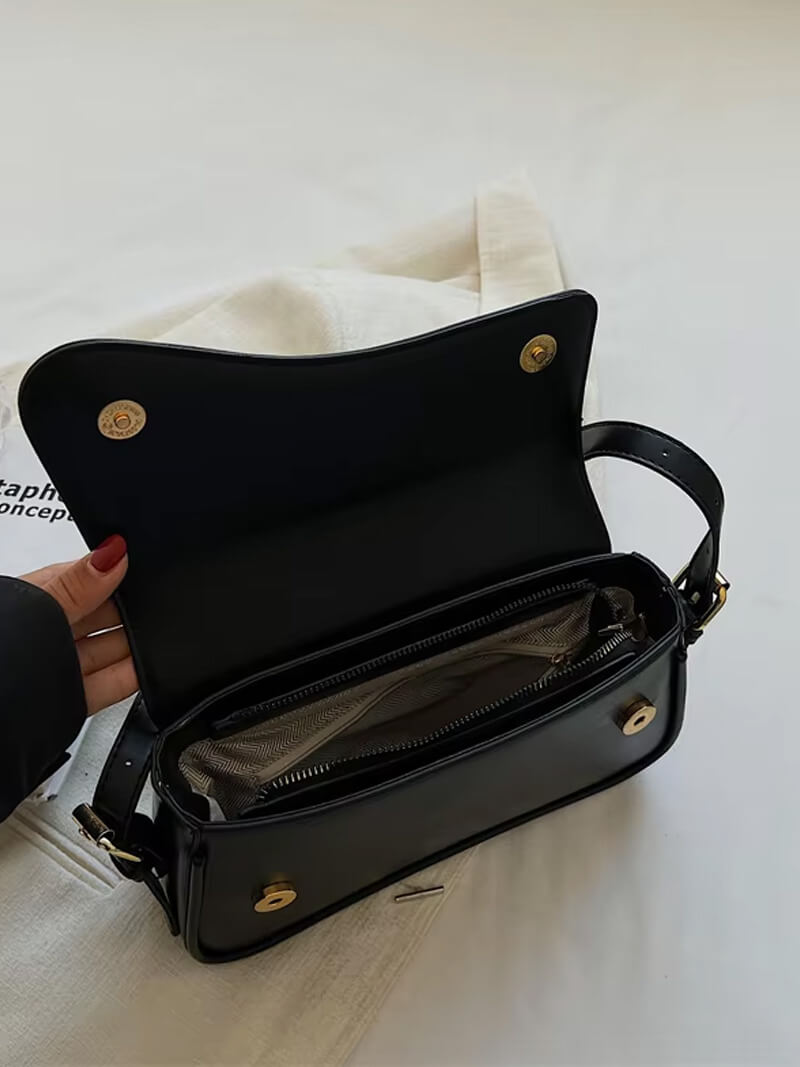 Compact shoulder bag with curved front detail and snap closure